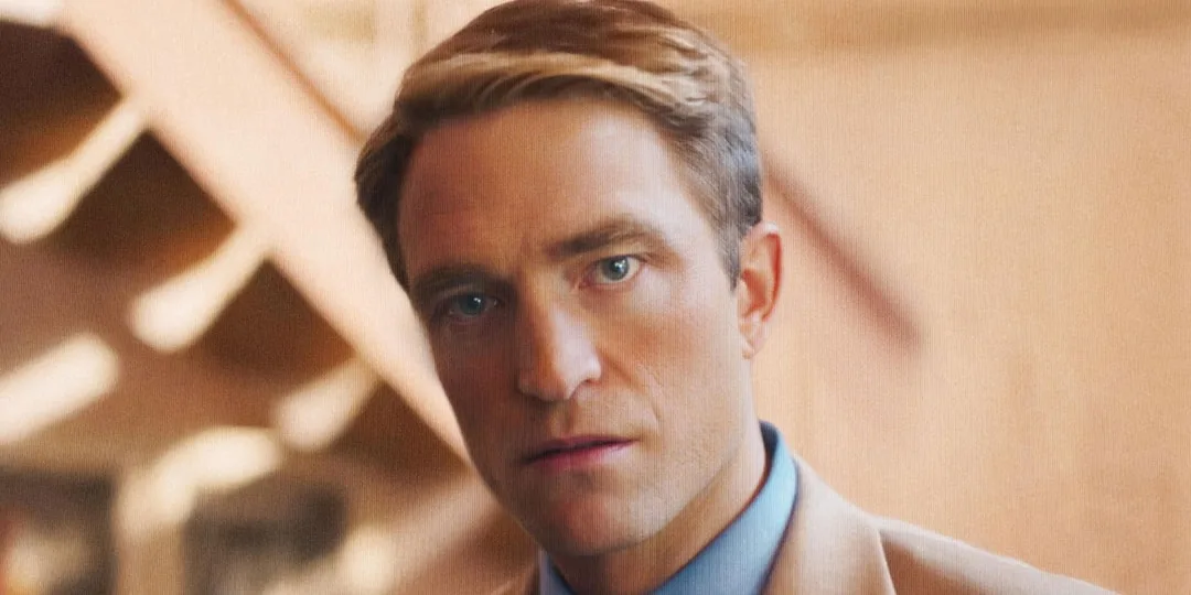 Homme blond en costume beige, lumière douce.