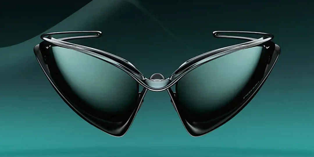 Lunettes de soleil futuristes sur fond vert, forme triangulaire élégante.