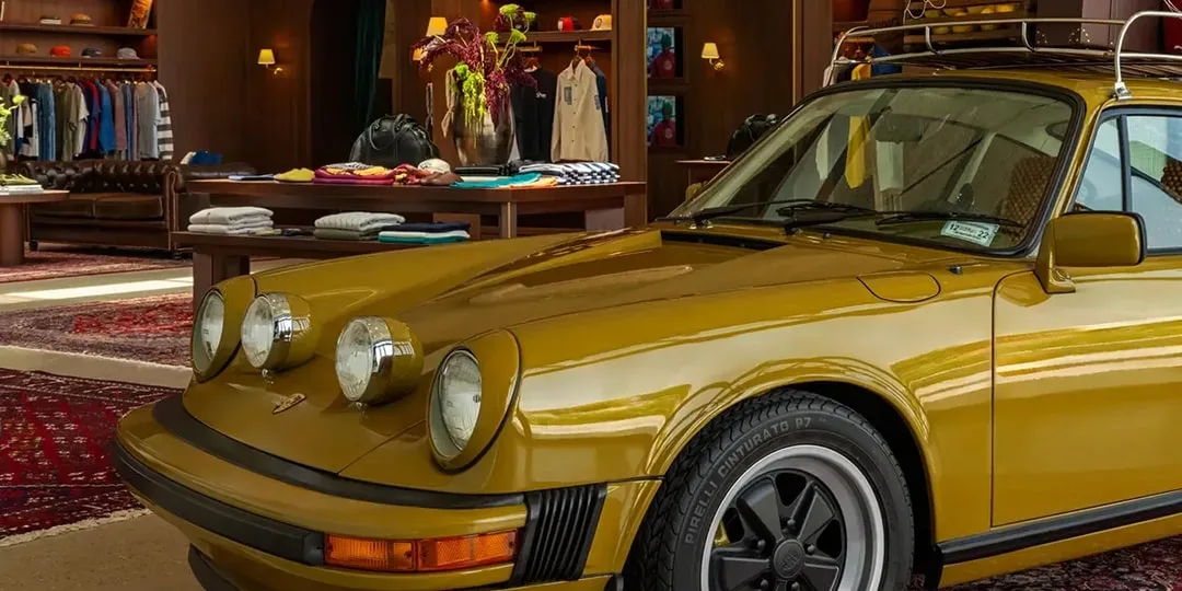 Voiture vintage dans magasin de vêtements chic avec tapis orientaux