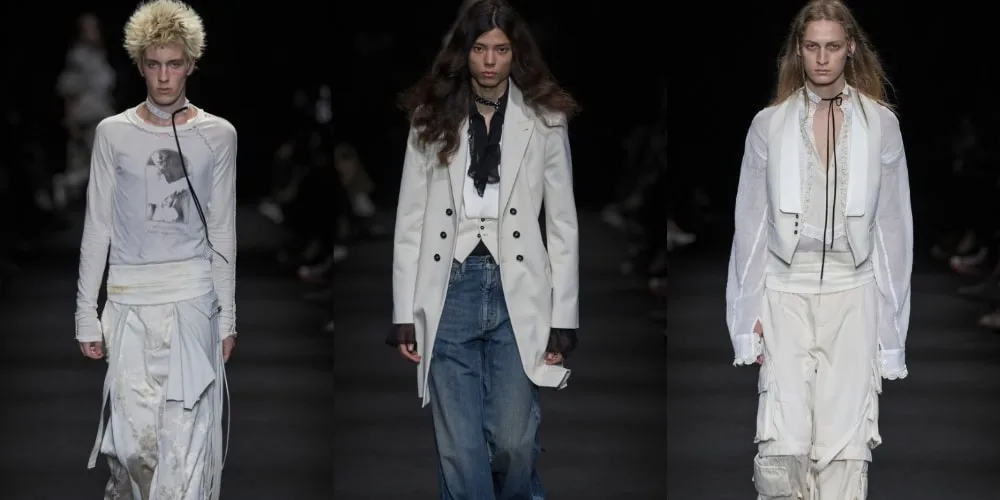 Défilé de mode avec trois mannequins portant des tenues modernes en blanc et noir.