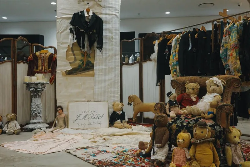 Magasin avec ours en peluche et vêtements vintage exposés.