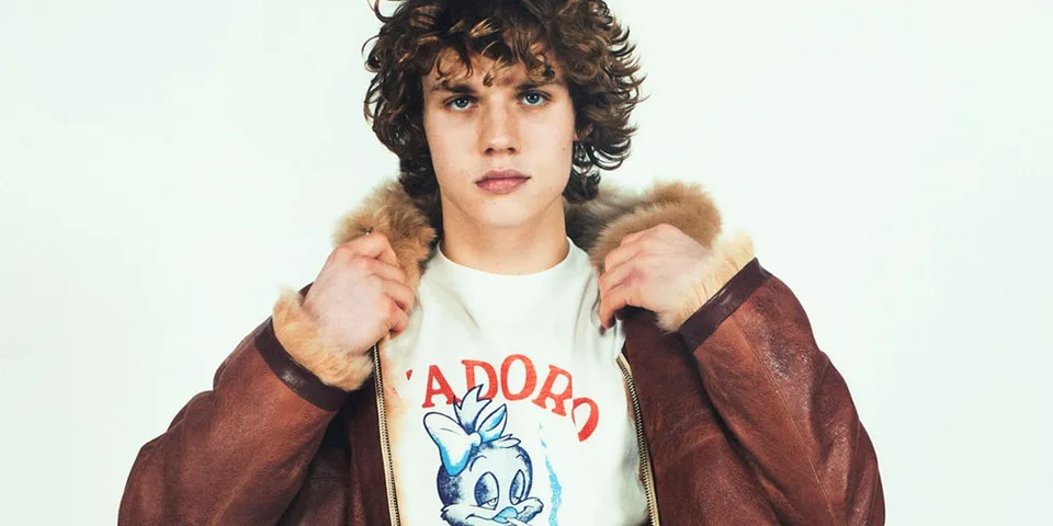 Jeune homme avec veste en cuir et t-shirt imprimé.