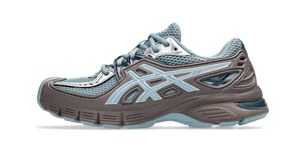 Chaussure de course Asics marron et bleu avec logo visible sur le côté.
