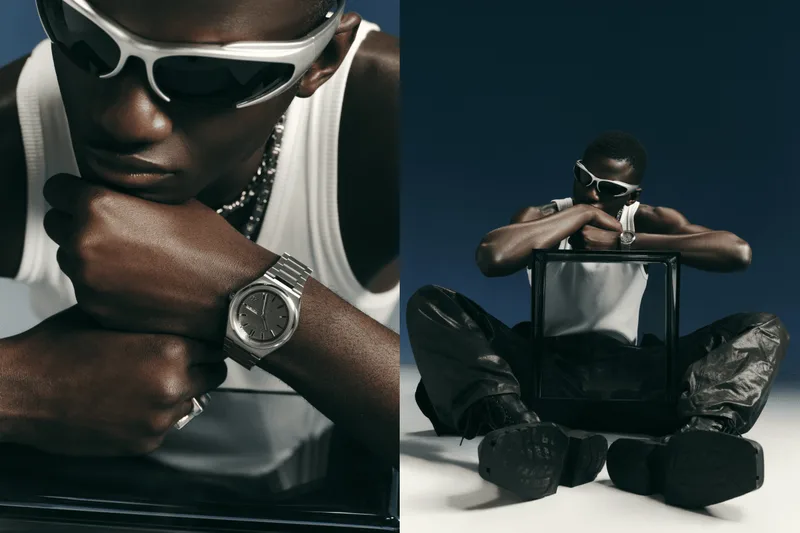 Homme avec lunettes de soleil et montre posant artistiquement.