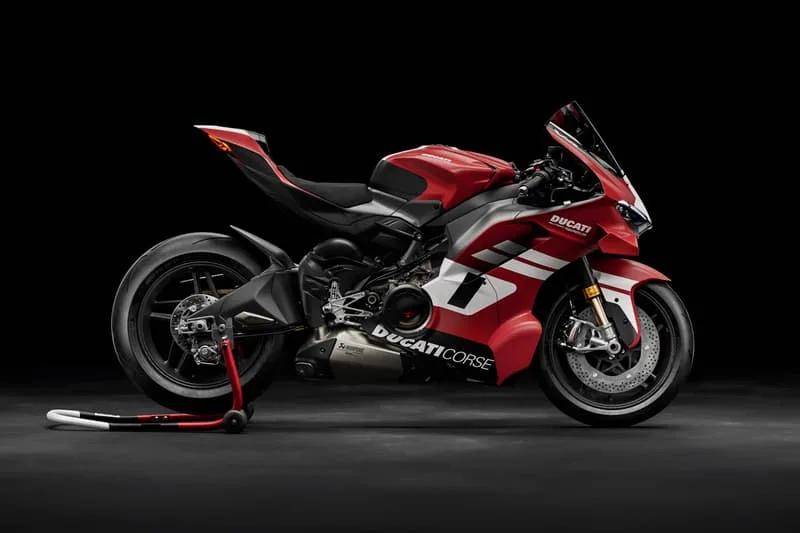 Moto de sport Ducati rouge et noire, vue latérale, sur fond noir.