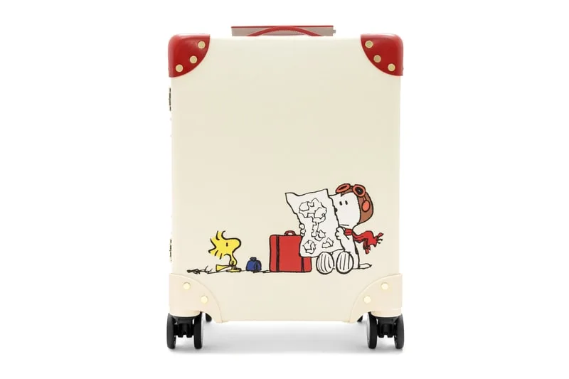 Valise blanche avec personnage de bande dessinée et carte.