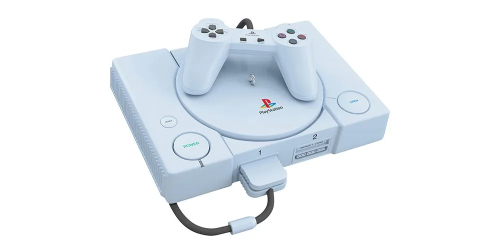Console de jeu rétro avec manette sur le dessus, design gris classique.