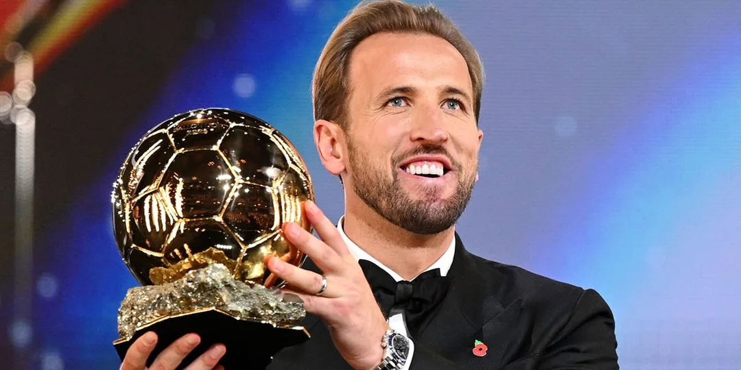 Harry Kane tient un trophée du Ballon d’Or lors d’une cérémonie.