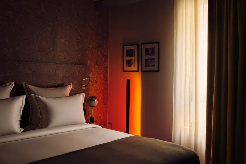 Chambre d'hôtel moderne avec lumière ambiante chaleureuse.