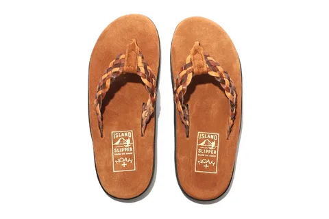 Sandales en cuir tressé couleur brun sur fond blanc.
