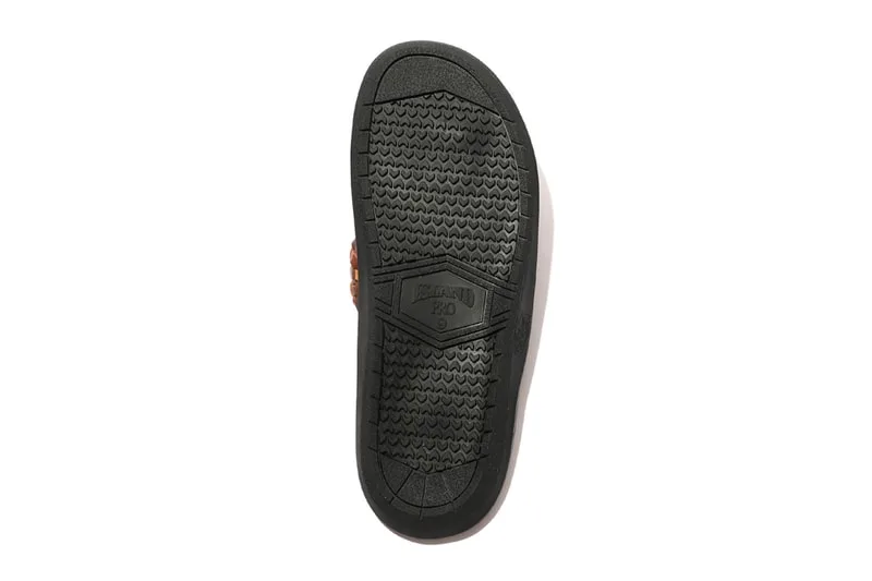 Semelle de chaussure en caoutchouc noir avec motifs texturés.