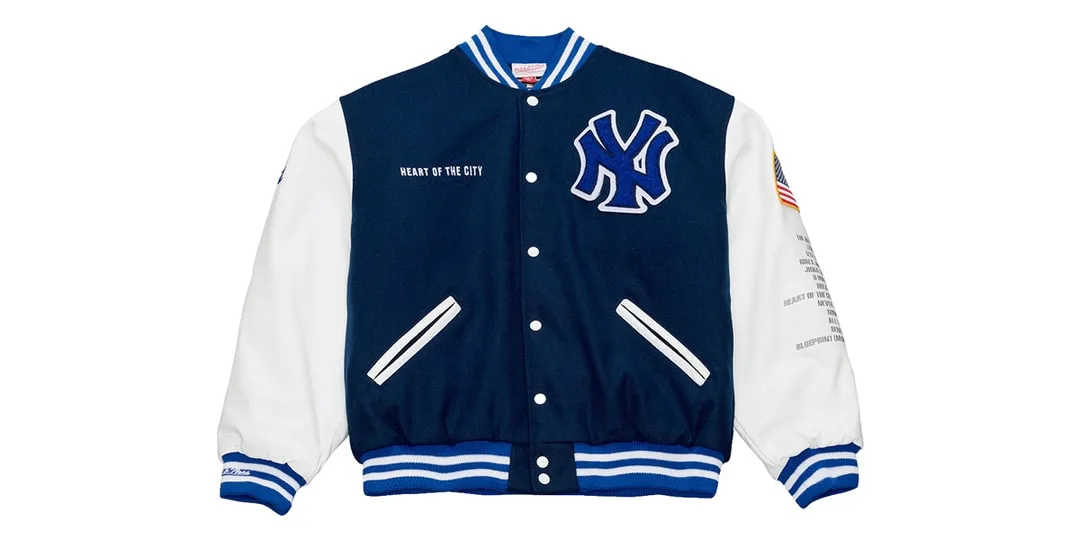 Veste varsity bleue et blanche avec logo NY à gauche.