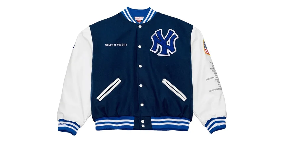 Veste varsity bleue et blanche avec logo NY à gauche.