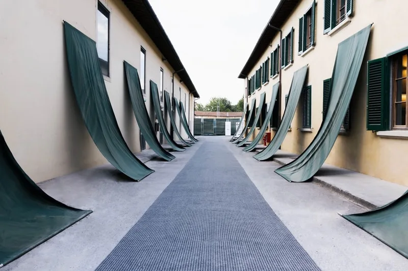 Bâtiment avec longs rideaux verts suspendus sur les côtés.