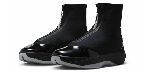 Chaussures noires élégantes avec zip central et bout verni.