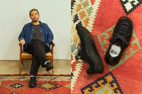 Homme assis et chaussures sur tapis coloré, style décontracté chic.