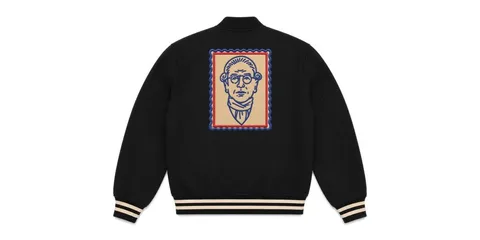 Veste noire avec illustration de visage au dos, bordures contrastées.