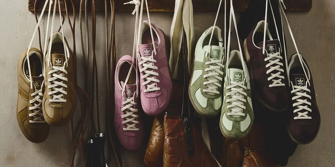 Chaussures colorées suspendues par leurs lacets contre un mur.