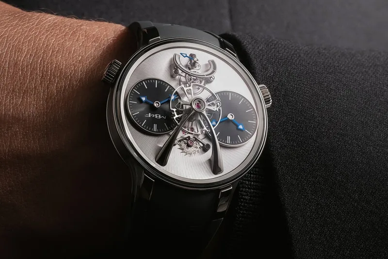Montre au poignet avec mécanisme visible et deux petits cadrans noirs.