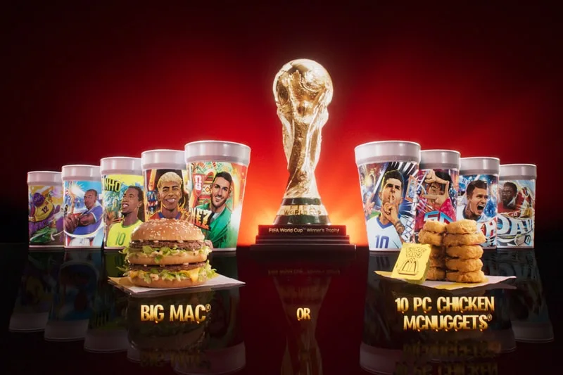 Trophée de la Coupe du Monde avec burger et nuggets en premier plan.