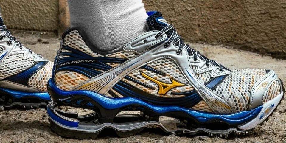 Basket de sport gris et bleu avec détails orange, vue à l'extérieur.