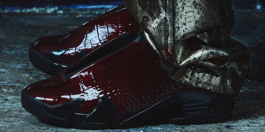 Chaussures en cuir rouge foncé avec pantalon à motif, sol en béton.