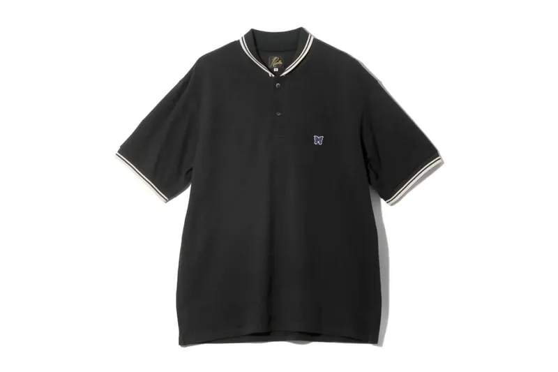 Polo noir avec papillon brodé sur la poitrine.