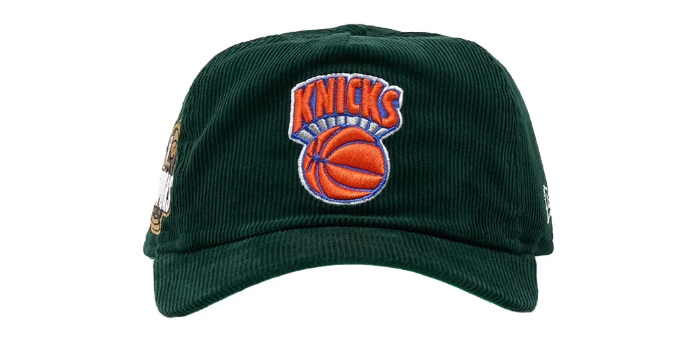 Casquette vert foncé des Knicks de New York avec logo brodé orange et bleu.