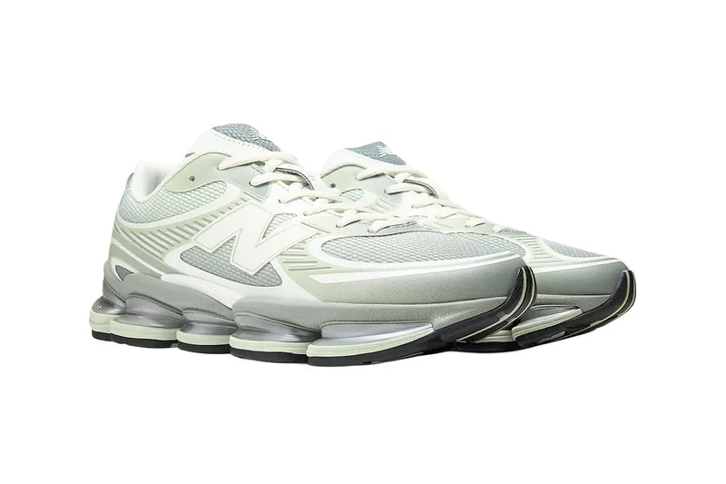 Chaussures de sport New Balance, couleur blanche et grise, semelles épaisses.