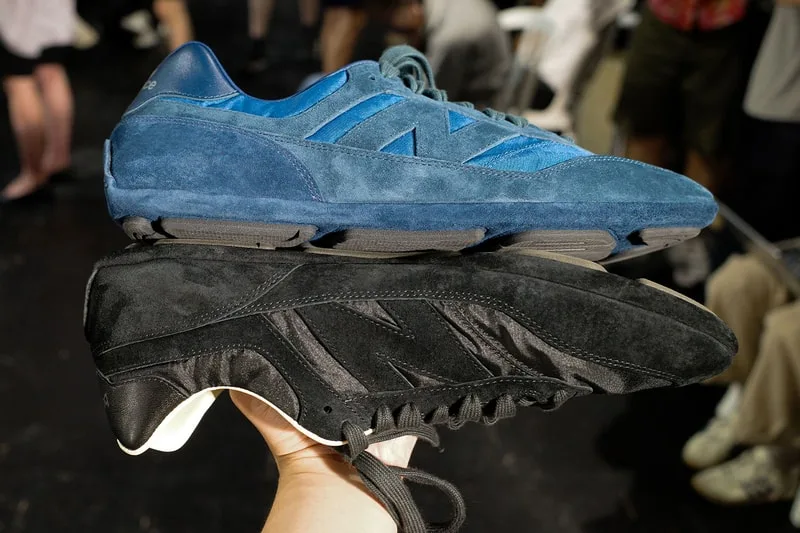 Deux paires de baskets bleues et noires tenues en main, vue en gros plan.