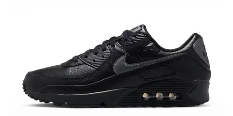 Chaussure noire avec détail texturé et coussin d'air visible.