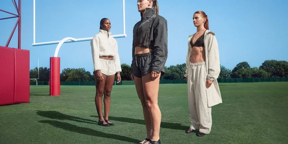Trois mannequins posent sur un terrain de sport en plein air.