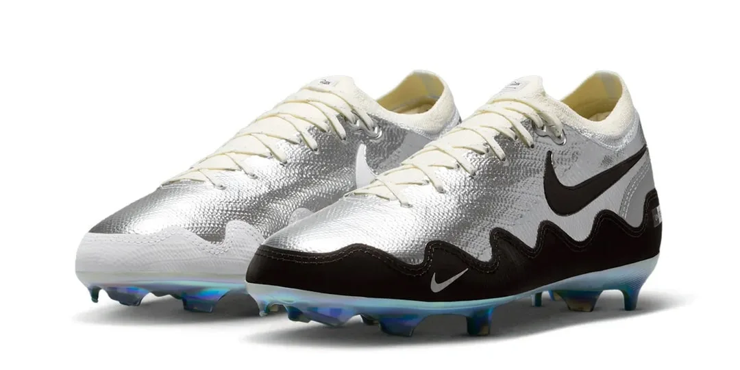Chaussures de football argentées et noires avec semelle colorée.