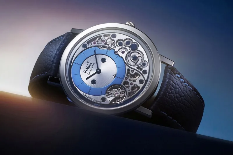 Montre mécanique sur bracelet en cuir avec cadran partiellement ouvert.