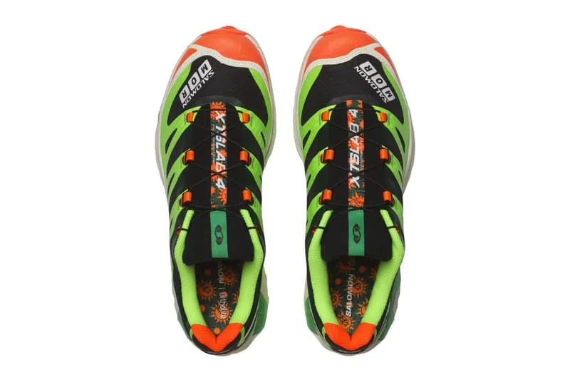 Chaussures de sport vertes et noires avec des accents orange.
