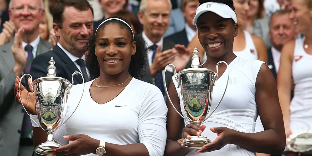 Deux joueuses de tennis avec des trophées à Wimbledon.