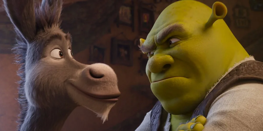 Un ogre vert et un âne parlent dans une pièce.