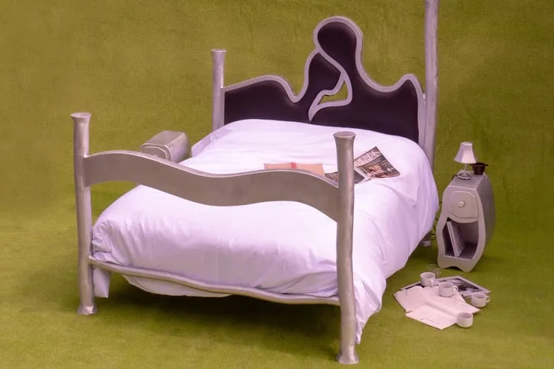 Lit insolite avec lampes et accessoires sur herbe verte
