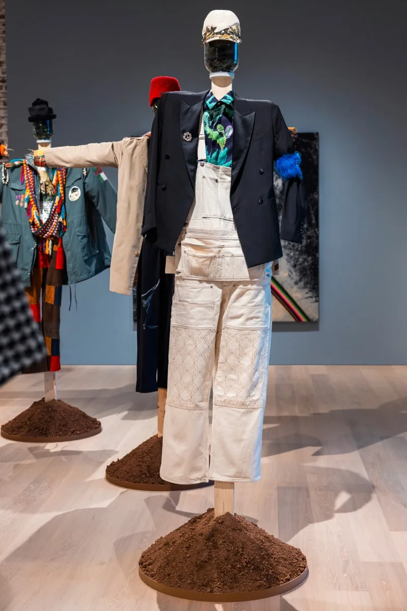 Mannequins avec des vêtements éclectiques sur monticules de terre.