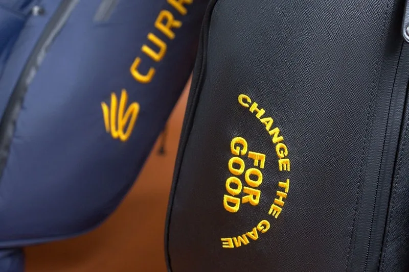 Sac noir avec texte 'CHANGE THE GAME FOR GOOD' en jaune